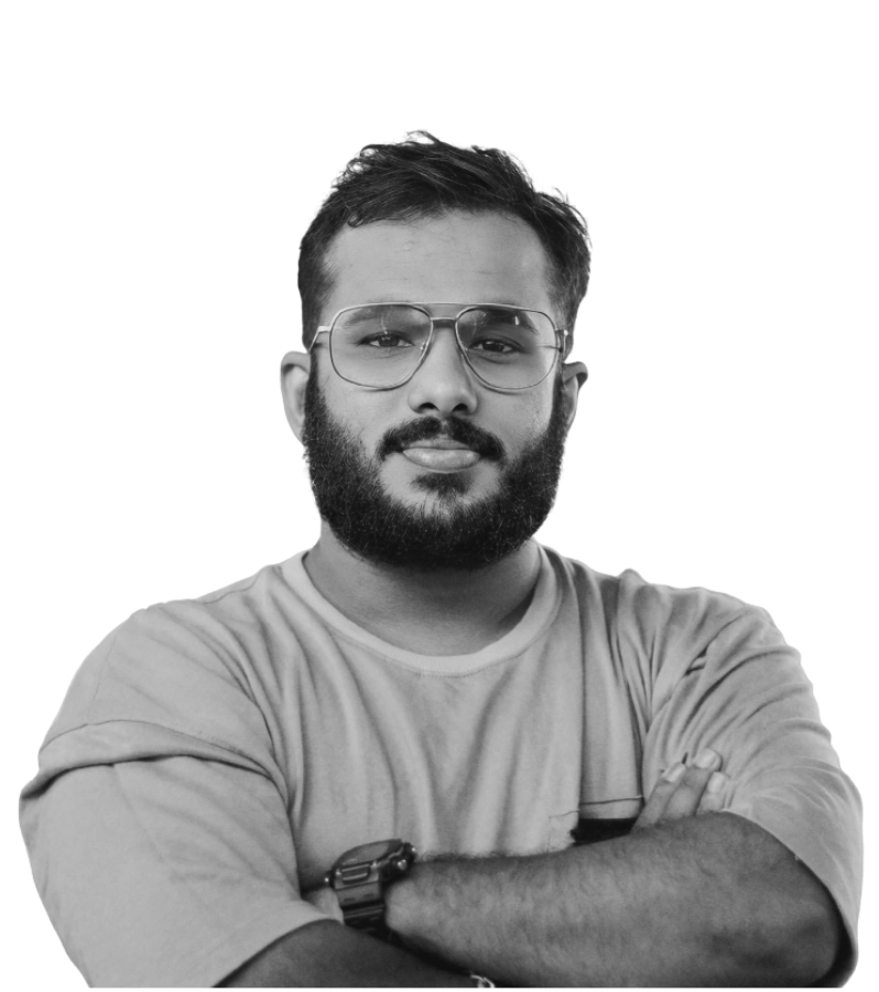 Antony Rainis P.M. standing confidently with folded arms